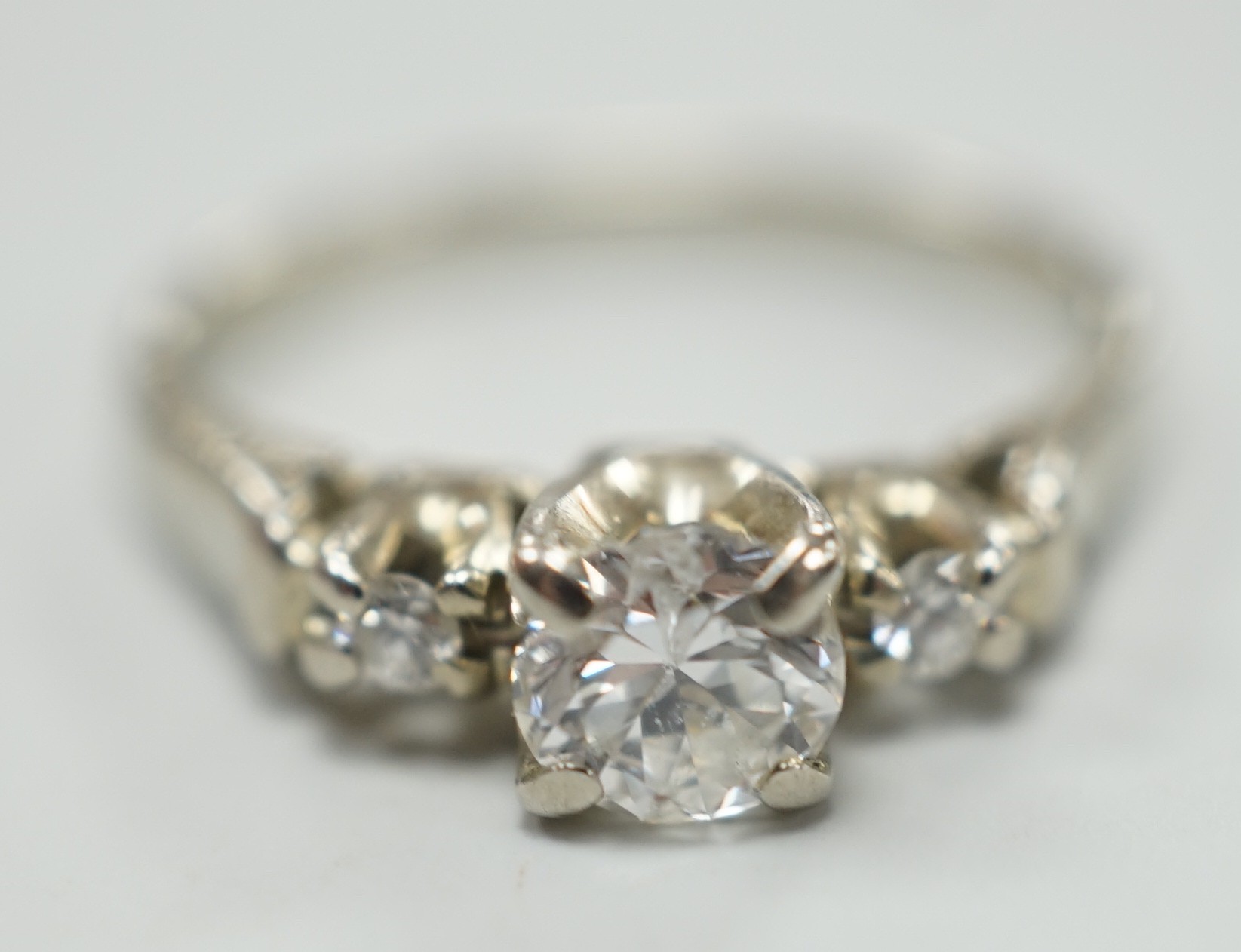 A Canadian Birks 18k white metal and single stone diamond ring, with diamond set shoulders, size H, gross weight 2.7 grams